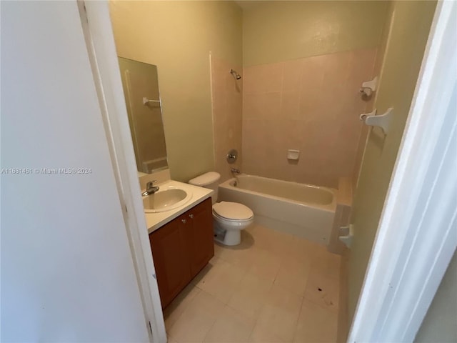 full bathroom featuring vanity, tiled shower / bath combo, and toilet