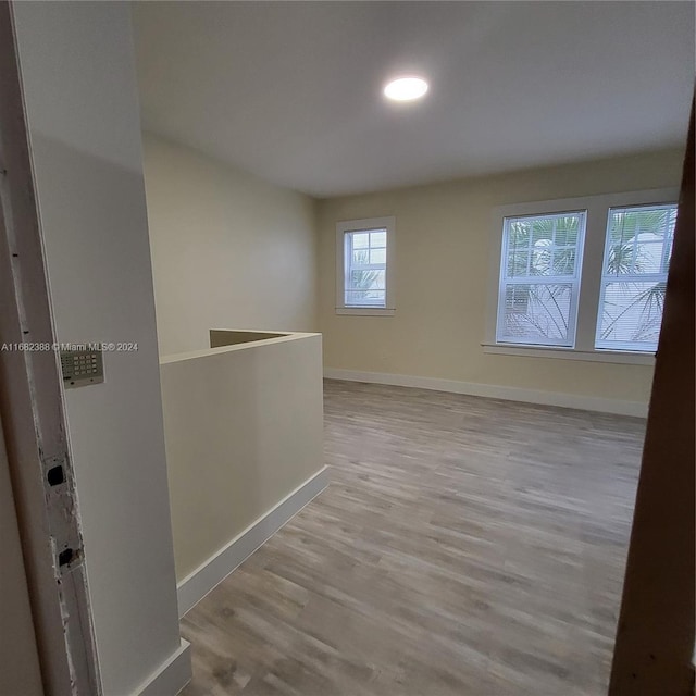 empty room with light hardwood / wood-style flooring