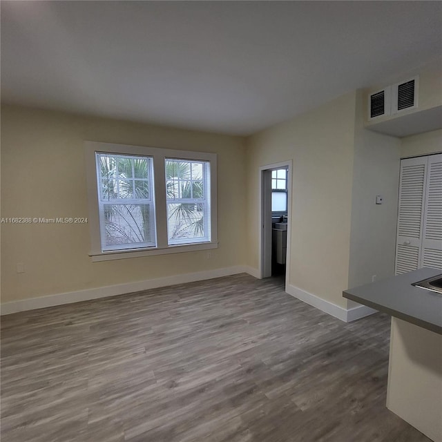 unfurnished living room with wood-type flooring