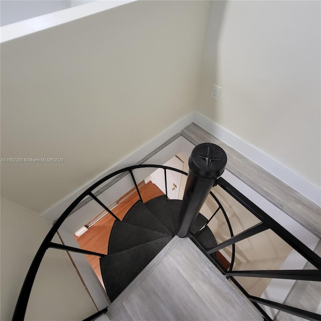 staircase featuring wood-type flooring