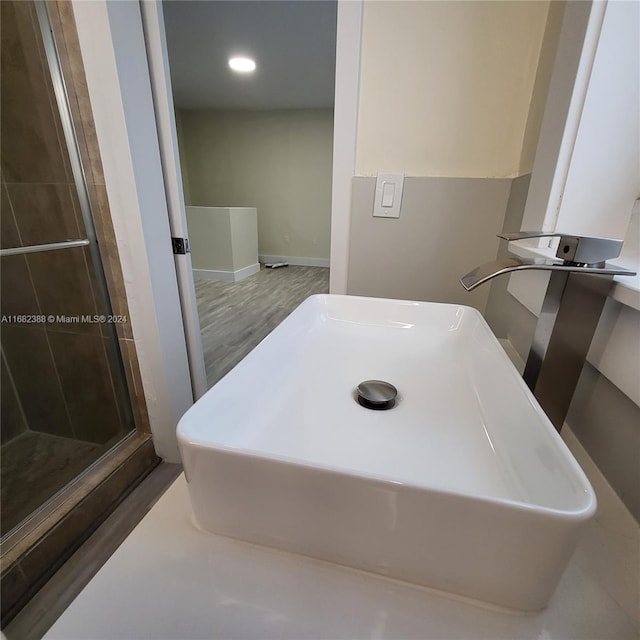 interior space featuring an enclosed shower and hardwood / wood-style floors