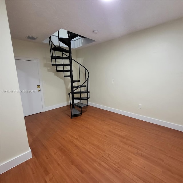 stairway featuring hardwood / wood-style flooring