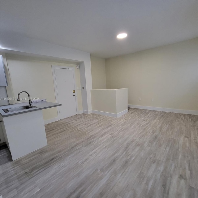 interior space featuring sink and light hardwood / wood-style floors