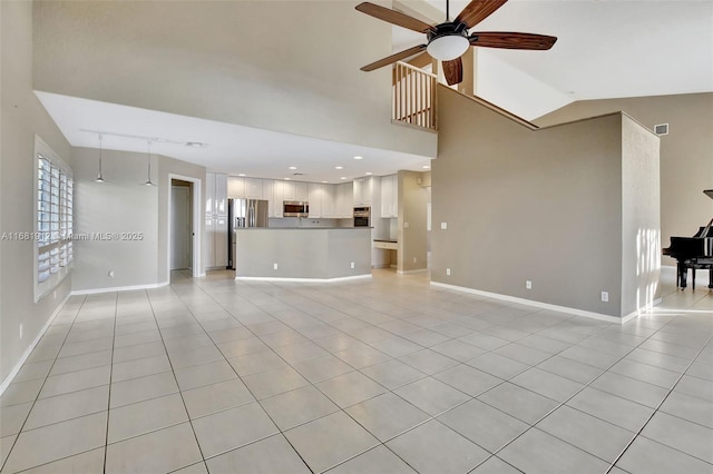 unfurnished living room featuring ceiling fan, light tile patterned floors, and lofted ceiling