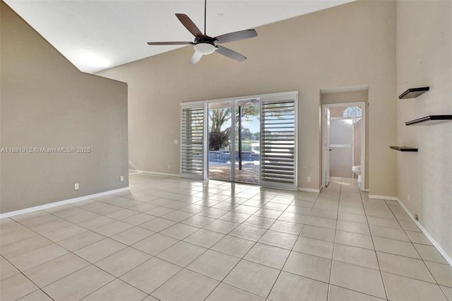 empty room featuring ceiling fan, light tile patterned floors, and high vaulted ceiling