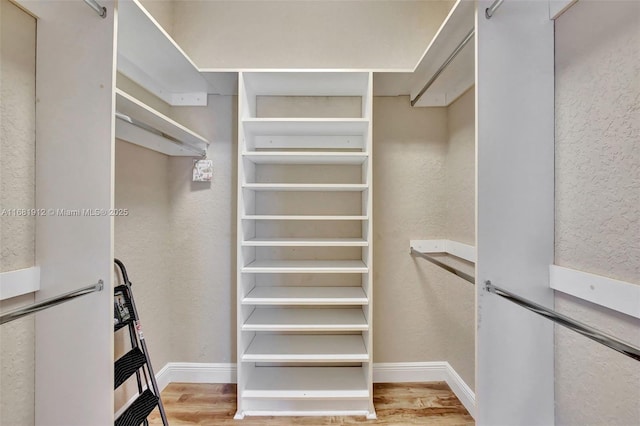 spacious closet with light hardwood / wood-style floors