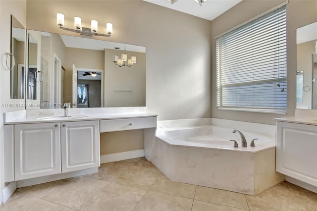 bathroom featuring tile patterned floors, ceiling fan with notable chandelier, a bath, and vanity