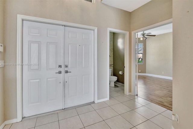 tiled entryway with ceiling fan