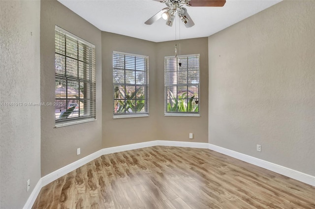 spare room featuring ceiling fan and wood-type flooring