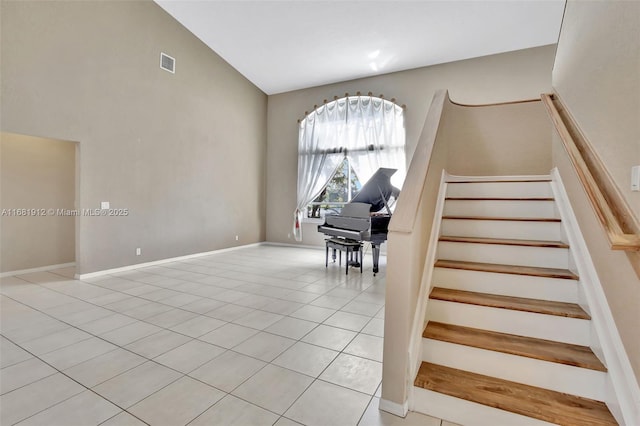 stairs featuring tile patterned floors and lofted ceiling