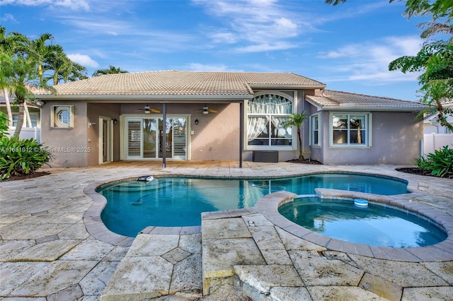 view of pool with an in ground hot tub, a patio, and ceiling fan