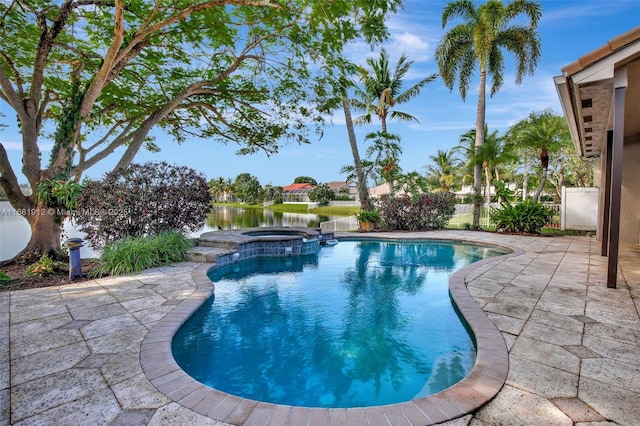 view of pool with a water view, an in ground hot tub, and a patio