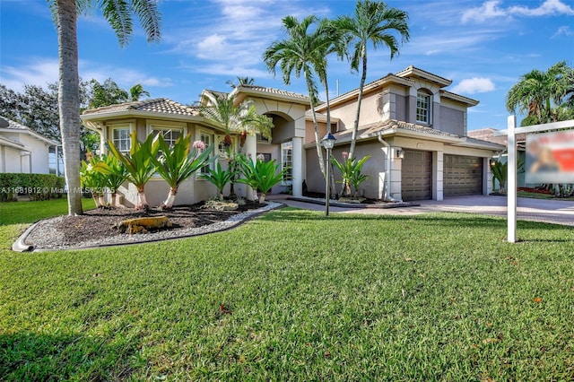 view of front of home featuring a front lawn and a garage