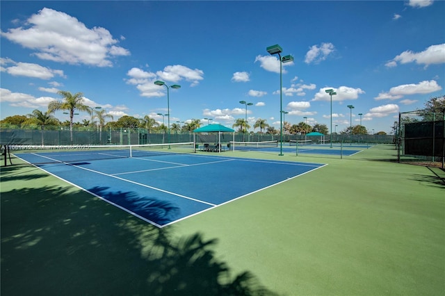 view of tennis court featuring basketball hoop