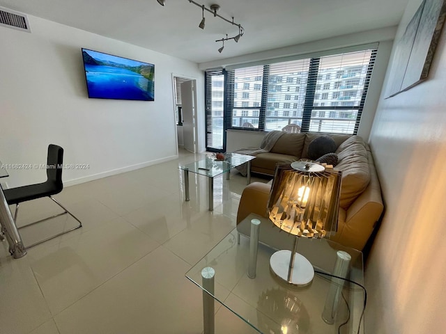 living room featuring tile patterned floors and rail lighting