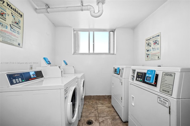 laundry room featuring independent washer and dryer and light tile patterned floors