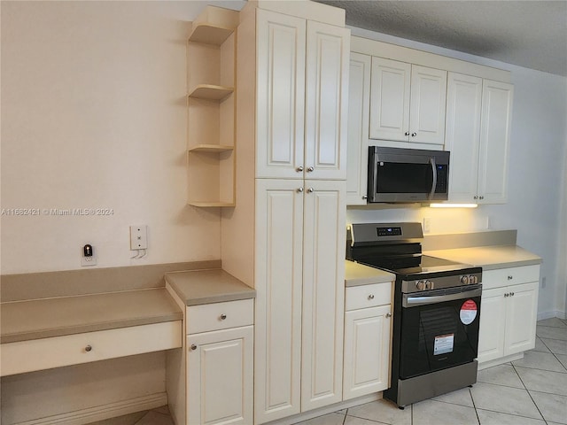 kitchen featuring white cabinets, light tile patterned flooring, and appliances with stainless steel finishes