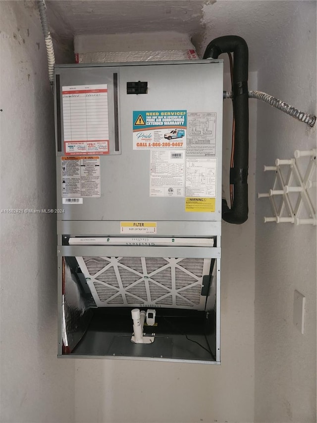 utility room featuring heating unit