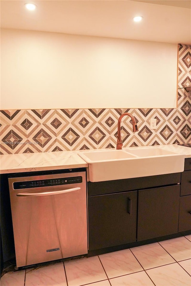 kitchen with dishwasher, sink, and light tile patterned floors