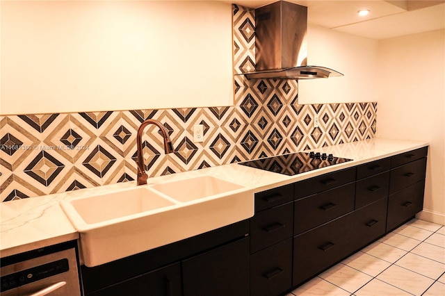 kitchen with wall chimney range hood, light tile patterned flooring, sink, black electric cooktop, and light stone counters