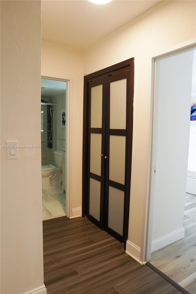 corridor featuring dark hardwood / wood-style floors