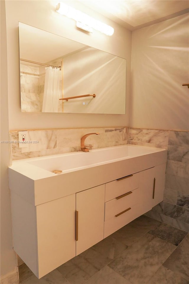 bathroom featuring tile walls and vanity