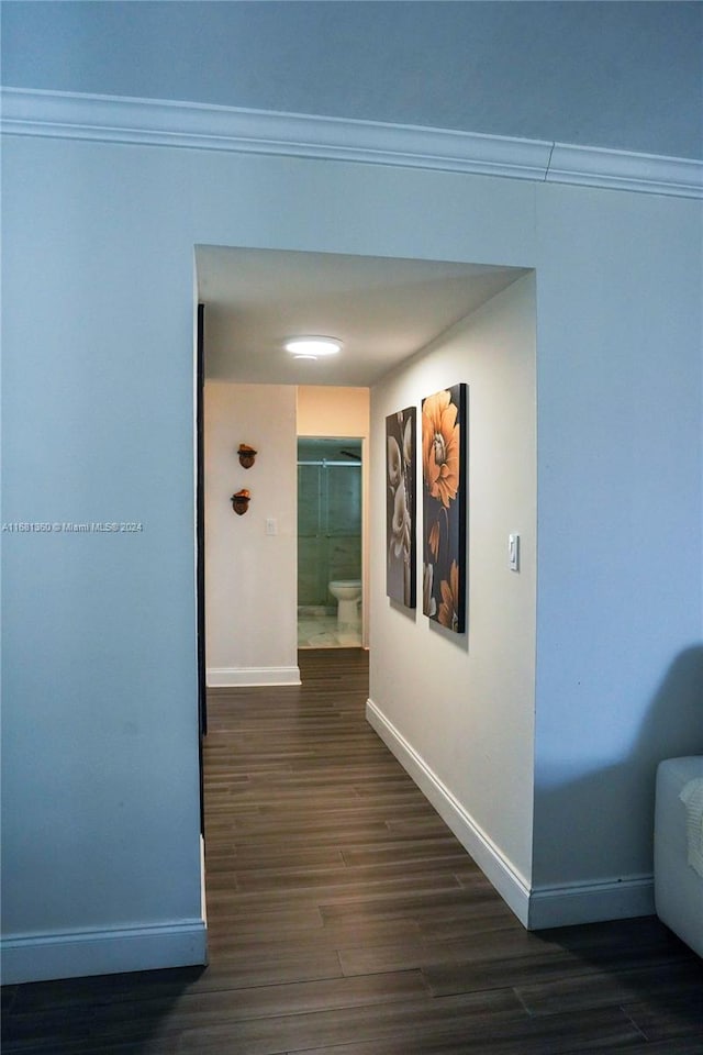 hall with crown molding and dark hardwood / wood-style flooring