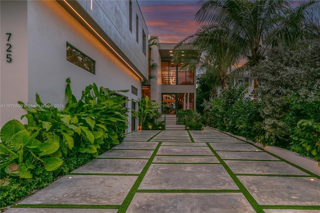 patio terrace at dusk featuring a garage