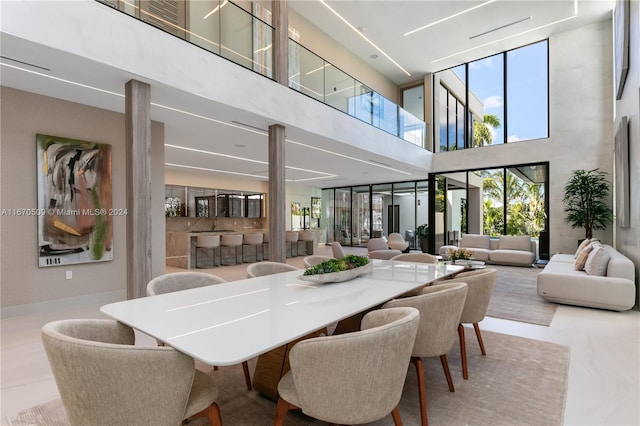 tiled dining area with a high ceiling