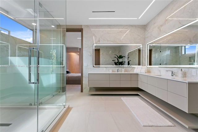 bathroom featuring vanity, tile patterned floors, an enclosed shower, and tile walls