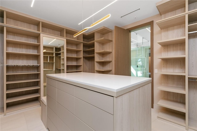 spacious closet with light tile patterned floors