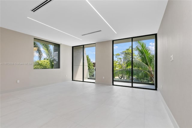 unfurnished room featuring floor to ceiling windows