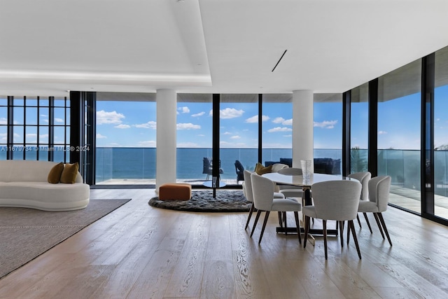 sunroom featuring a water view