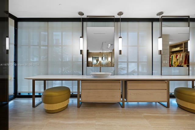 bathroom with sink and a wall of windows