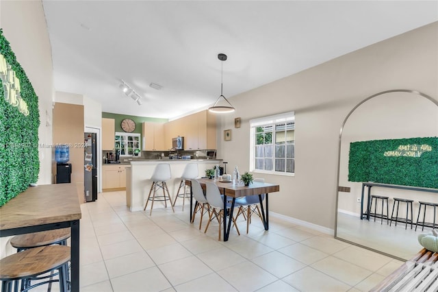 dining room featuring track lighting and light tile patterned floors