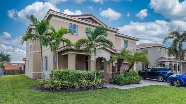 mediterranean / spanish house featuring a front yard