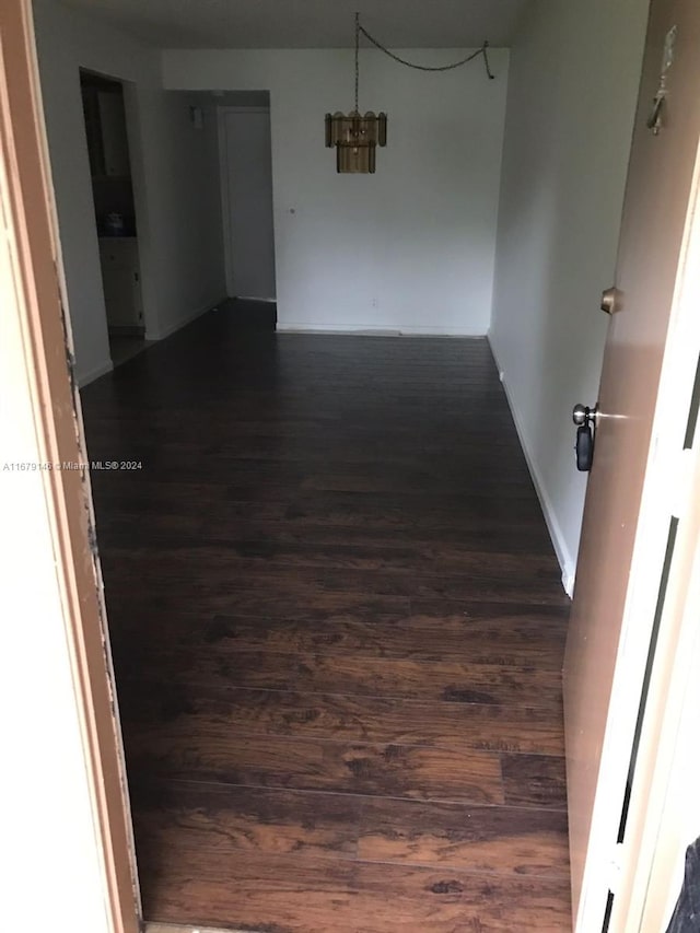 hallway with dark wood-type flooring