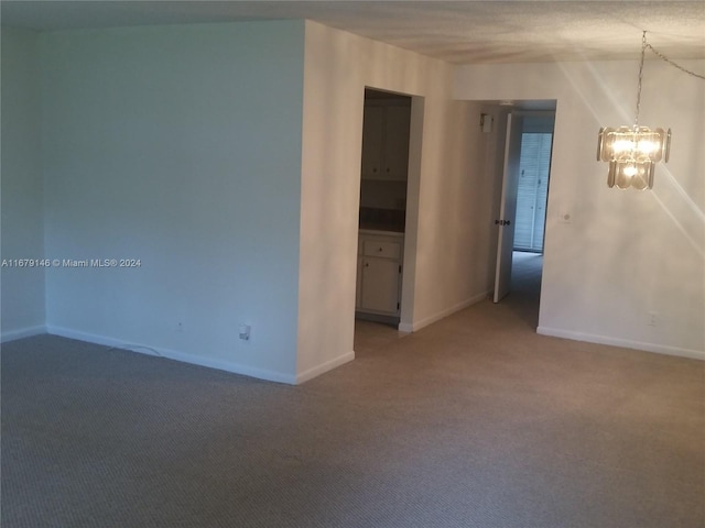 13350 SW 1st St Unit 109P, Pembroke Pines, FL 33027 - empty room featuring a chandelier, light colored carpet, and baseboards