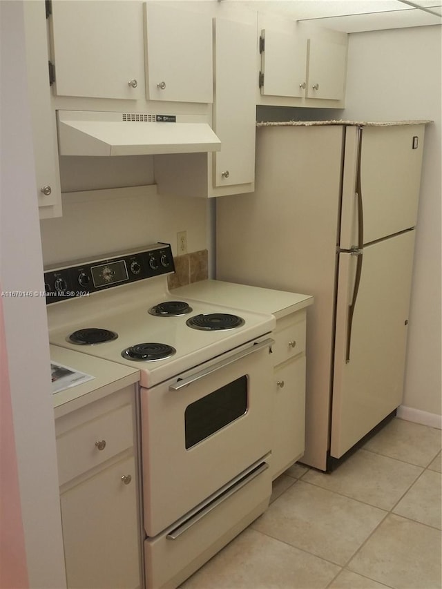 kitchen with white cabinets, white electric range, exhaust hood, and light tile patterned floors