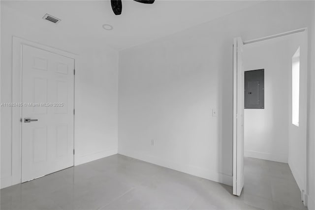 unfurnished room featuring electric panel