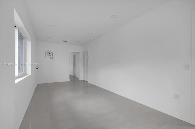 spare room with concrete flooring