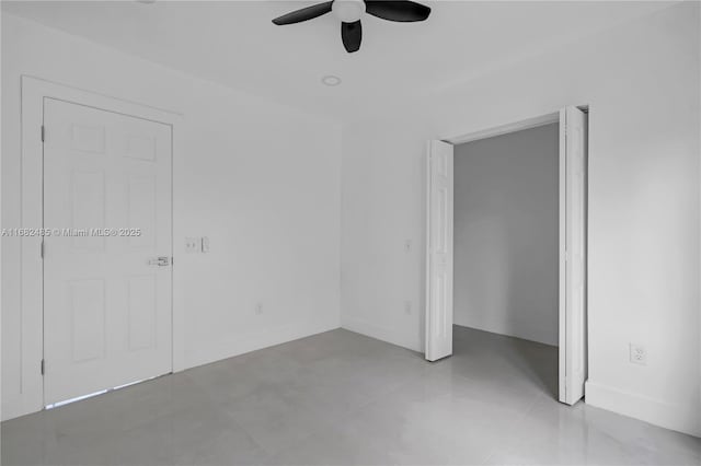 unfurnished bedroom with ceiling fan and light tile patterned floors