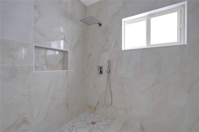 bathroom with a tile shower