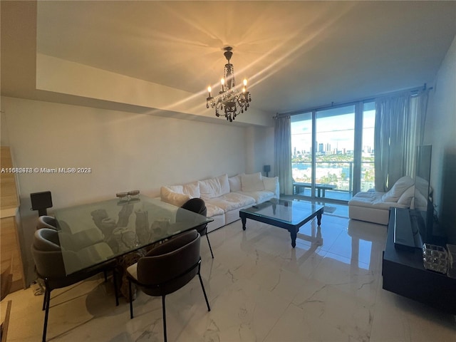 living area featuring a chandelier and marble finish floor