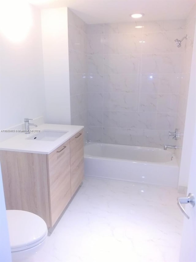 bathroom featuring shower / bathtub combination, toilet, marble finish floor, and vanity
