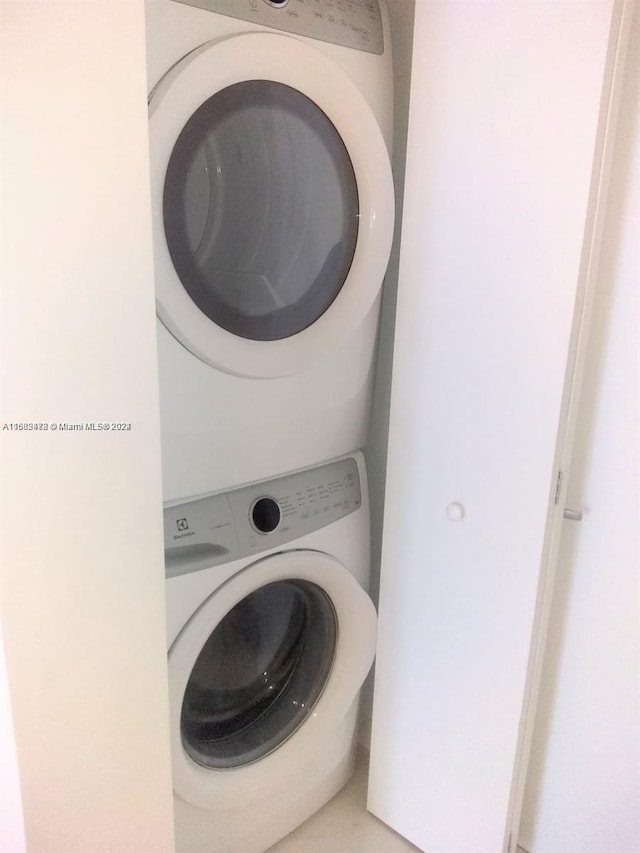 laundry room with stacked washing maching and dryer and laundry area