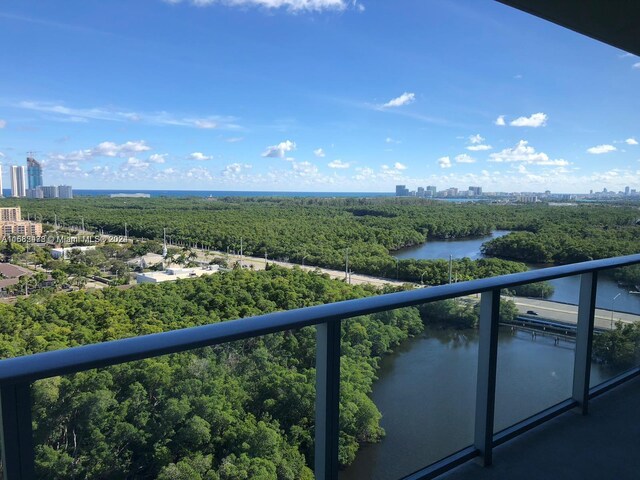 balcony with a view of city and a water view