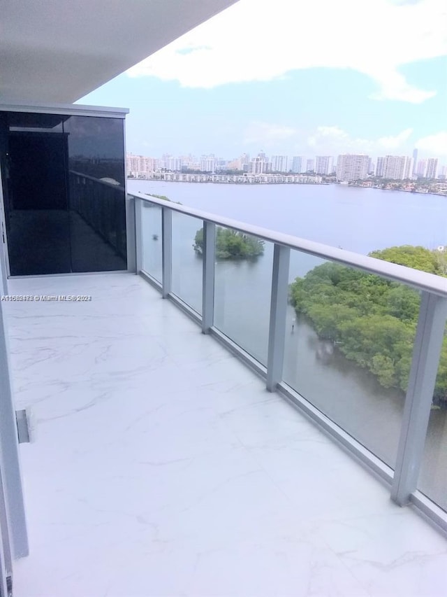 balcony featuring a view of city and a water view