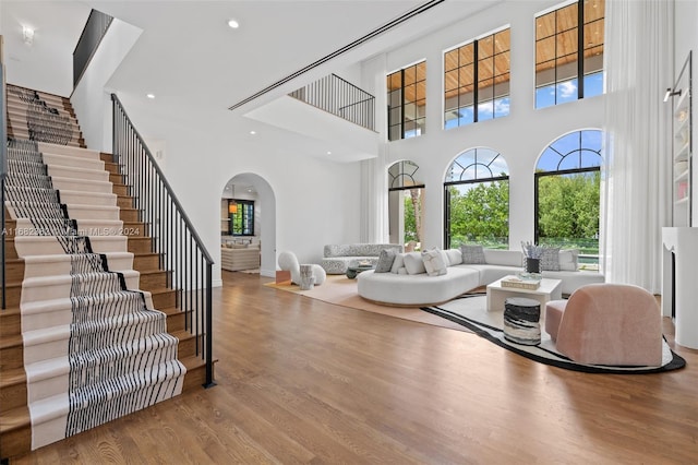 living room with a high ceiling and light hardwood / wood-style floors