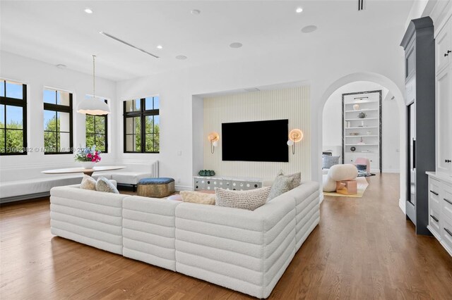 406 Tamarind Dr, Hallandale Beach, FL 33009 - living area featuring arched walkways, built in features, dark wood-style floors, and recessed lighting